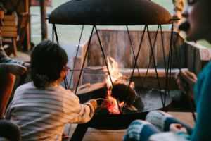 children roasting marshmallows at a fire pit